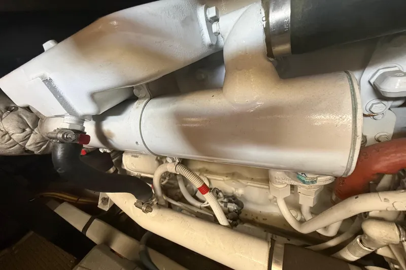 Y-knot Yacht Photos Pics Engine compartment of a 2007 Meridian 459 Motoryacht, showcasing mechanical components and hoses.