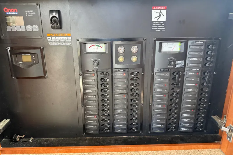 Y-knot Yacht Photos Pics Electrical control panel of a 2007 Meridian 459 Motoryacht, featuring Onan e-Series generator controls.