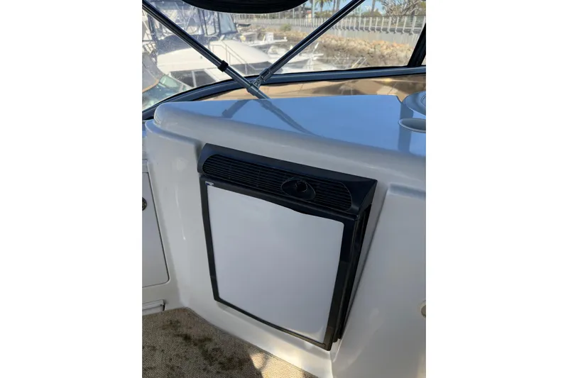 Y-knot Yacht Photos Pics 2007 Meridian 459 Motoryacht interior with compact refrigerator and window view.