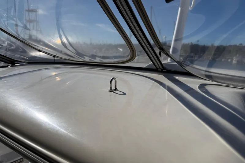 Y-knot Yacht Photos Pics Close-up of 2007 Meridian 459 Motoryacht deck with clear canopy and metal fitting.