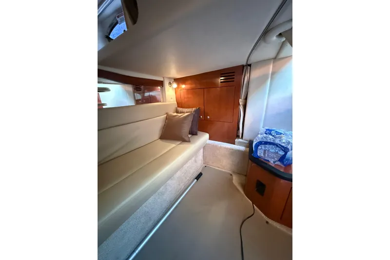  Yacht Photos Pics Interior of 2007 Sea Ray 340 boat with beige seating and wooden cabinetry.
