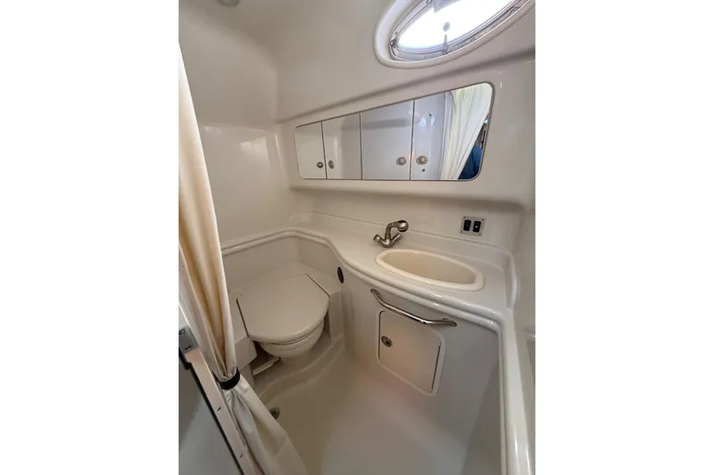  Yacht Photos Pics 2007 Sea Ray 340 yacht bathroom with sink, toilet, and mirrored cabinet.