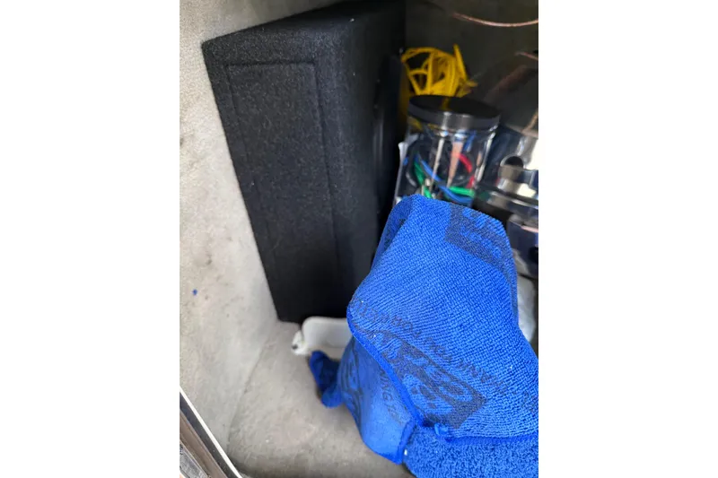  Yacht Photos Pics Storage compartment in a 2007 Sea Ray 340 boat with blue towel and wires.