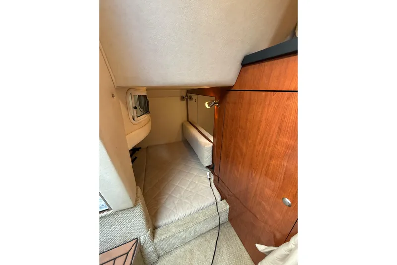  Yacht Photos Pics 2007 Sea Ray 340 cabin interior with wood paneling and cozy sleeping area.