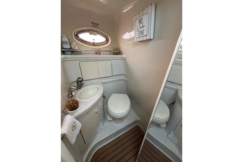  Yacht Photos Pics 2007 Sea Ray 340 yacht bathroom with sink, toilet, and "No Wake Zone" sign.