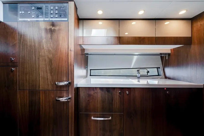  Yacht Photos Pics Luxurious 2024 Fairline Targa 50 GT yacht interior with sleek wooden cabinetry and modern fixtures.