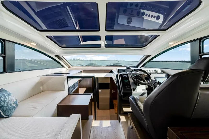  Yacht Photos Pics Luxurious interior of 2024 Fairline Targa 50 GT yacht with panoramic windows and modern helm.