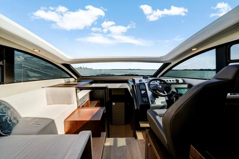  Yacht Photos Pics 2024 Fairline Targa 50 GT yacht interior with modern helm and seating, under a clear blue sky.