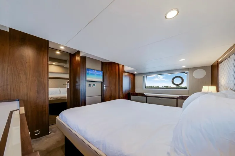  Yacht Photos Pics Luxurious 2024 Fairline Targa 50 GT yacht bedroom with modern design and scenic window view.