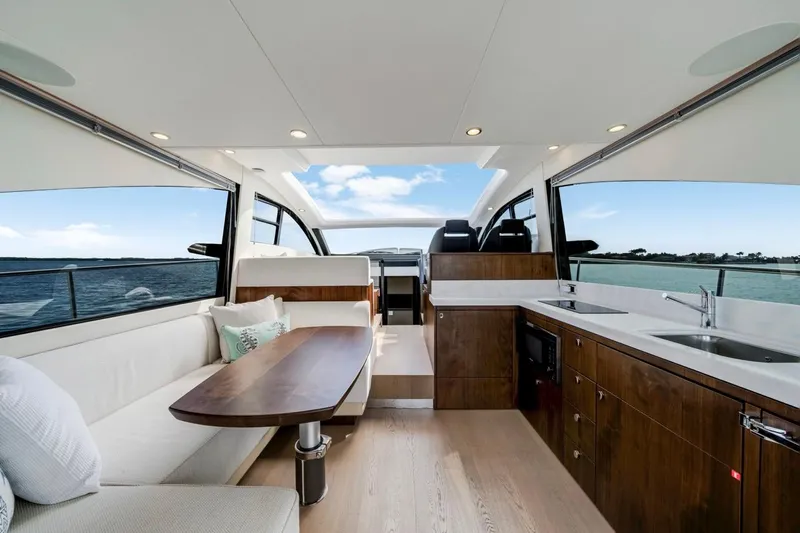  Yacht Photos Pics Luxurious interior of 2024 Fairline Targa 50 GT yacht with modern kitchen and seating area.