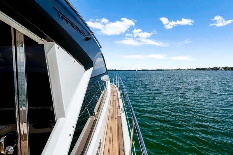  Yacht Photos Pics 2024 Fairline Targa 50 GT yacht cruising on open water under a clear blue sky.