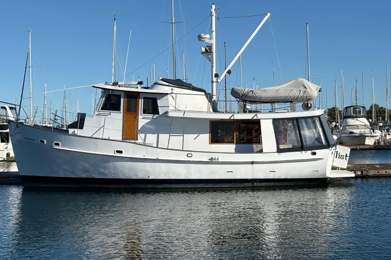 Kallisto Yacht Photos Pics 1982 Kadey-Krogen Krogen 42 Trawler docked in a marina under clear blue skies.