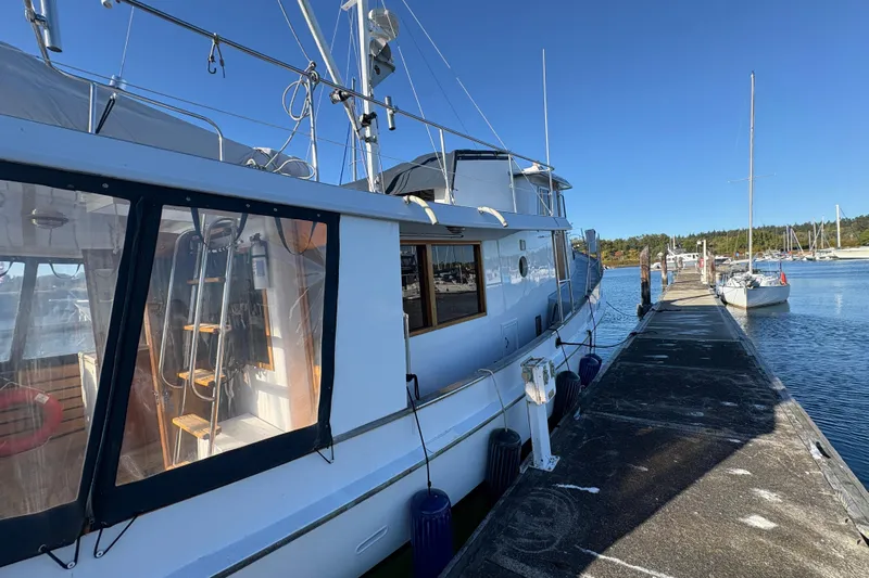 Kallisto Yacht Photos Pics 1982 Kadey-Krogen Krogen 42 Trawler docked at a marina under clear blue skies.