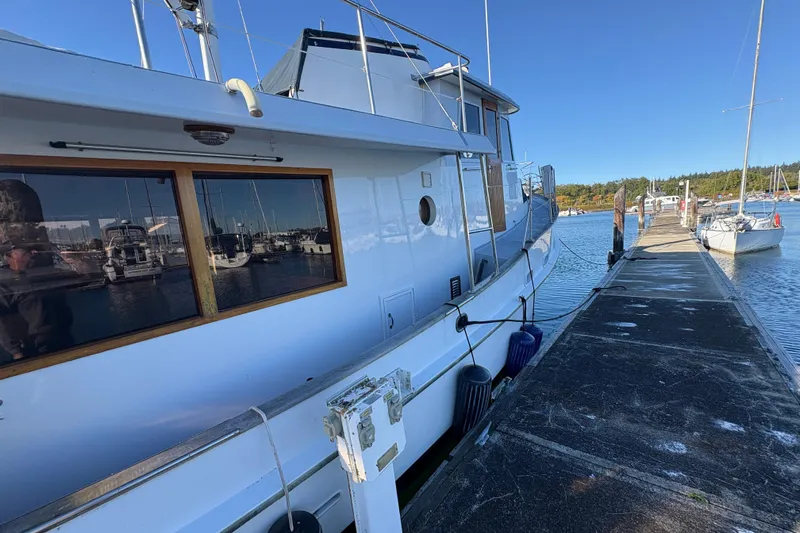 Kallisto Yacht Photos Pics 1982 Kadey-Krogen Krogen 42 Trawler docked at marina under clear blue sky.