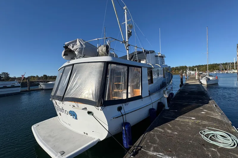 Kallisto Yacht Photos Pics 1982 Kadey-Krogen Krogen 42 Trawler docked at marina under clear blue sky.