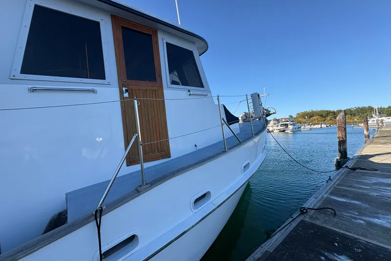 Kallisto Yacht Photos Pics 1982 Kadey-Krogen Krogen 42 Trawler docked at marina under clear blue sky.