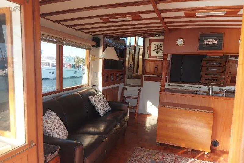 Kallisto Yacht Photos Pics Interior of 1982 Kadey-Krogen Krogen 42 Trawler with wooden decor and leather sofa.