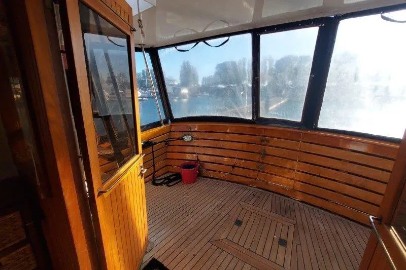 Kallisto Yacht Photos Pics 1982 Kadey-Krogen Krogen 42 Trawler interior with wooden paneling and large windows.