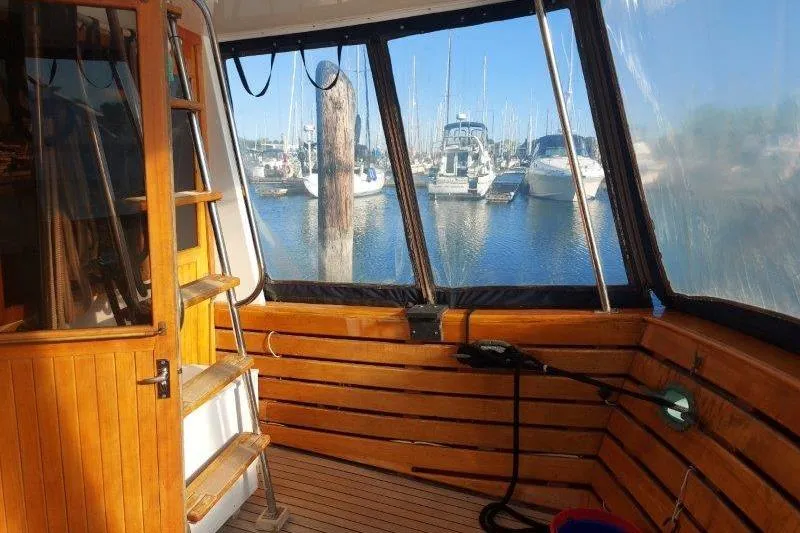 Kallisto Yacht Photos Pics 1982 Kadey-Krogen Krogen 42 Trawler interior with marina view through windows.