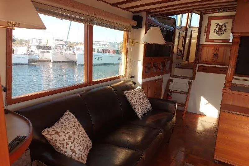 Kallisto Yacht Photos Pics Interior of 1982 Kadey-Krogen Krogen 42 Trawler with leather sofa and large windows.