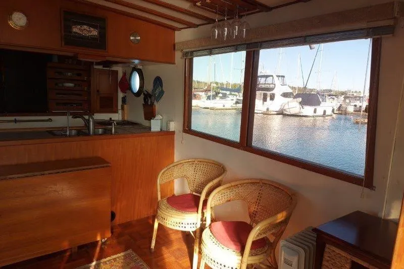Kallisto Yacht Photos Pics Interior of 1982 Kadey-Krogen Krogen 42 Trawler with marina view through large window.