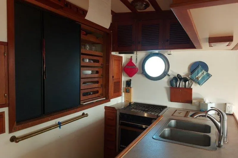 Kallisto Yacht Photos Pics 1982 Kadey-Krogen Krogen 42 Trawler kitchen with stove, sink, and porthole window.