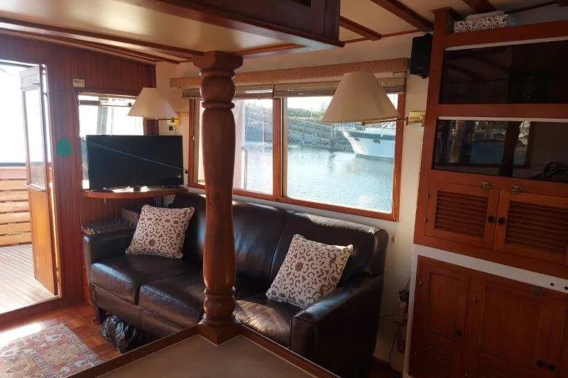 Kallisto Yacht Photos Pics Interior of 1982 Kadey-Krogen Krogen 42 Trawler with leather sofa and waterfront view.