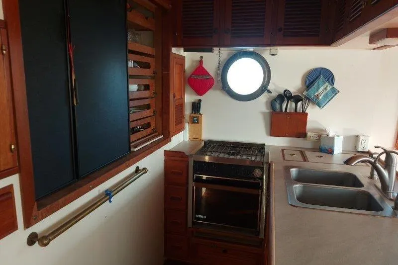 Kallisto Yacht Photos Pics 1982 Kadey-Krogen Krogen 42 Trawler kitchen with stove, sink, and porthole window.