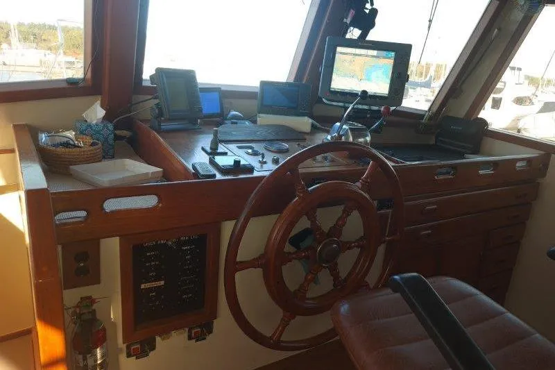 Kallisto Yacht Photos Pics 1982 Kadey-Krogen Krogen 42 Trawler helm with wooden wheel and navigation equipment.
