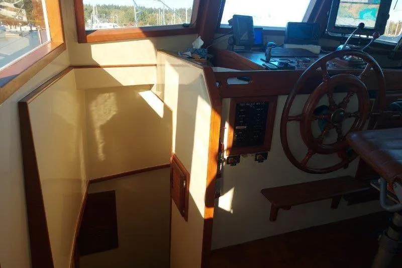 Kallisto Yacht Photos Pics 1982 Kadey-Krogen Krogen 42 Trawler helm with wooden wheel and navigation equipment.
