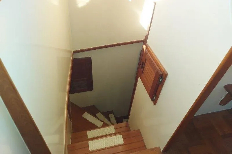 Kallisto Yacht Photos Pics Staircase inside 1982 Kadey-Krogen Krogen 42 Trawler, featuring wooden steps and white walls.