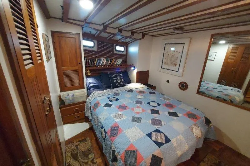 Kallisto Yacht Photos Pics Cozy bedroom in 1982 Kadey-Krogen Krogen 42 Trawler with quilted bedspread and wooden accents.