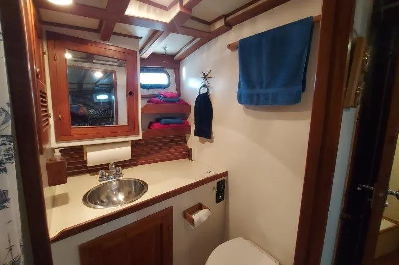 Kallisto Yacht Photos Pics 1982 Kadey-Krogen Krogen 42 Trawler bathroom with wooden accents and nautical decor.