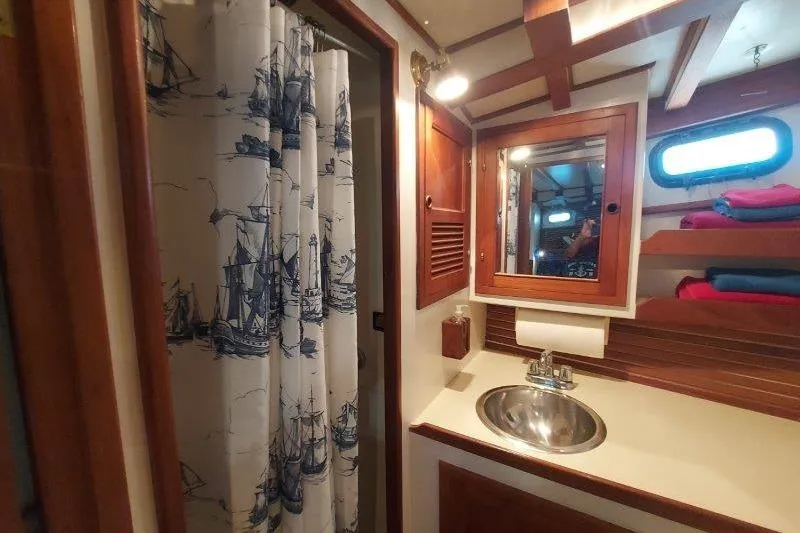 Kallisto Yacht Photos Pics 1982 Kadey-Krogen Krogen 42 Trawler bathroom with nautical decor and wooden accents.