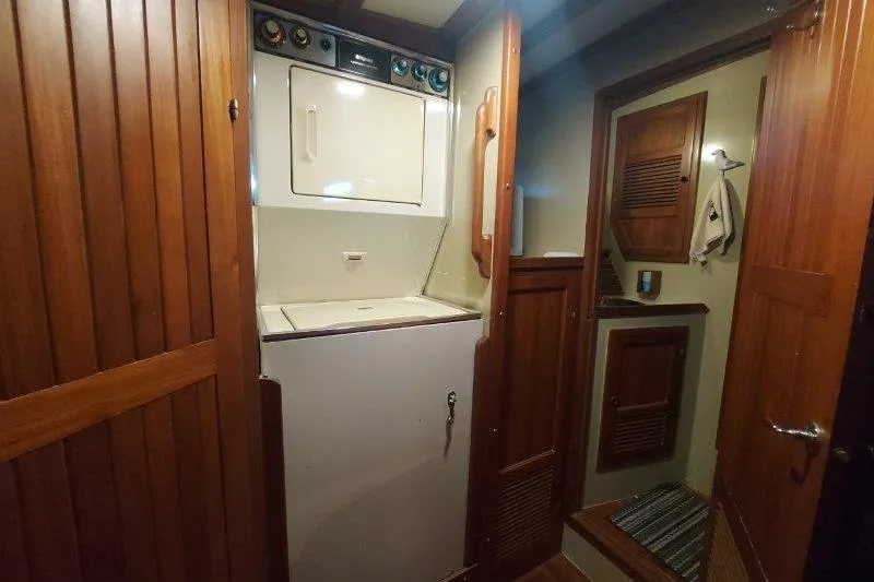 Kallisto Yacht Photos Pics Laundry area inside 1982 Kadey-Krogen Krogen 42 Trawler with wooden cabinetry.