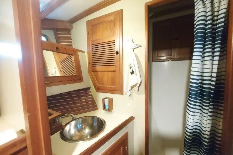Kallisto Yacht Photos Pics 1982 Kadey-Krogen Krogen 42 Trawler bathroom with wooden cabinetry and stainless steel sink.
