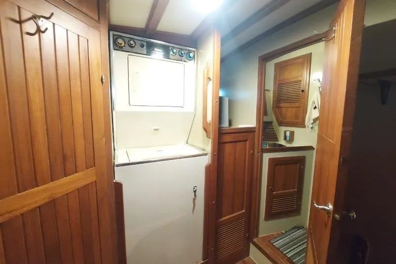 Kallisto Yacht Photos Pics 1982 Kadey-Krogen Krogen 42 Trawler interior with wooden cabinetry and laundry area.