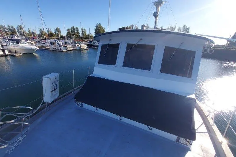 Kallisto Yacht Photos Pics 1982 Kadey-Krogen Krogen 42 Trawler docked in a marina under clear blue sky.
