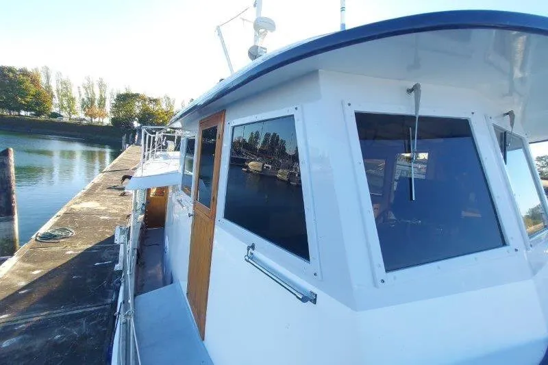 Kallisto Yacht Photos Pics 1982 Kadey-Krogen Krogen 42 Trawler docked by a serene waterfront.