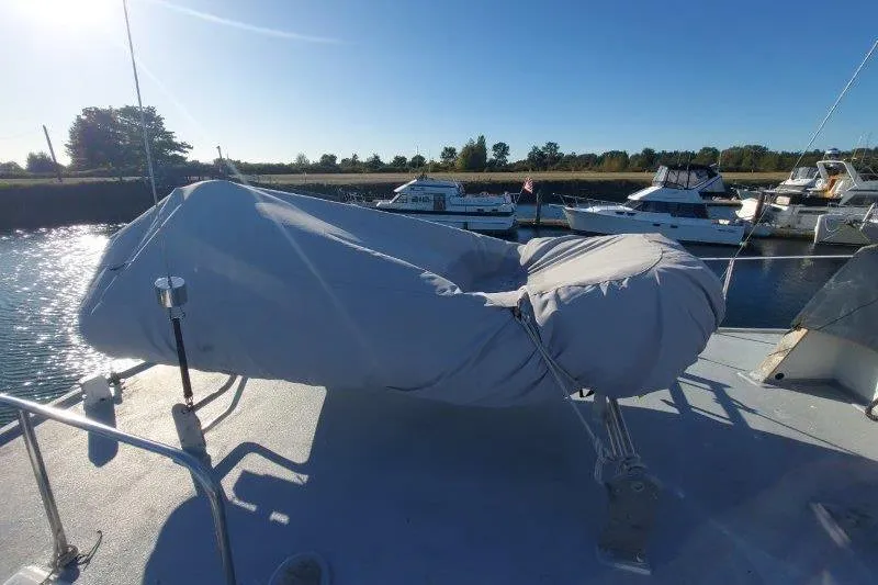 Kallisto Yacht Photos Pics 1982 Kadey-Krogen Krogen 42 Trawler with covered equipment on deck, docked in a marina.