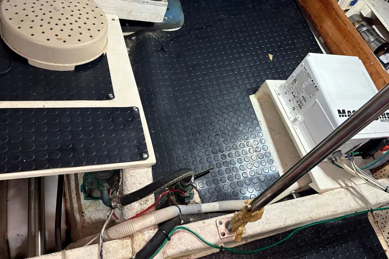 Kallisto Yacht Photos Pics 1982 Kadey-Krogen Pilothouse interior with equipment and wiring on textured flooring.