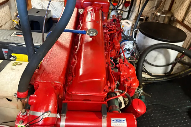 Kallisto Yacht Photos Pics Engine room of 1982 Kadey-Krogen Pilothouse with red marine engine and hoses.