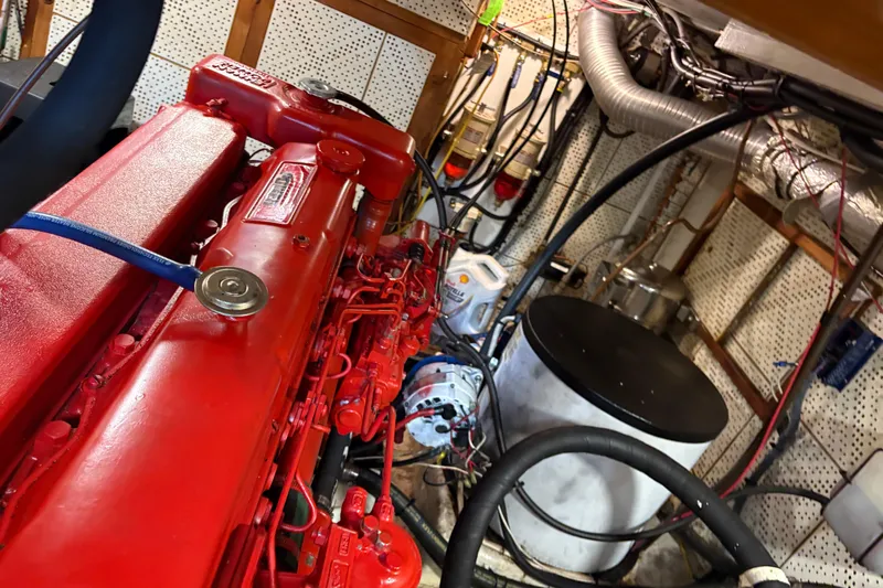 Kallisto Yacht Photos Pics Engine room of a 1982 Kadey-Krogen Pilothouse with red machinery and wiring.