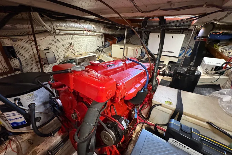 Kallisto Yacht Photos Pics Engine room of a 1982 Kadey-Krogen Pilothouse with a red marine engine.