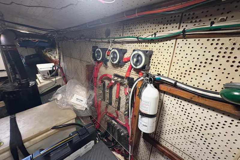 Kallisto Yacht Photos Pics Engine room of 1982 Kadey-Krogen Pilothouse with wiring, switches, and fire extinguisher.