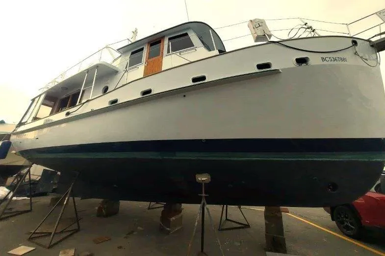 Kallisto Yacht Photos Pics 1982 Kadey-Krogen Pilothouse boat on stands, side view, in a shipyard.