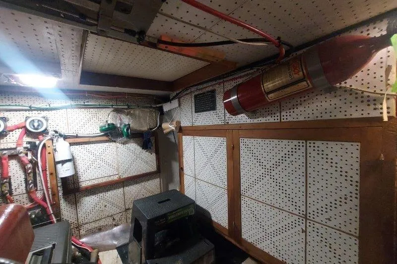 Kallisto Yacht Photos Pics 1982 Kadey-Krogen Pilothouse engine room with fire extinguisher and equipment.