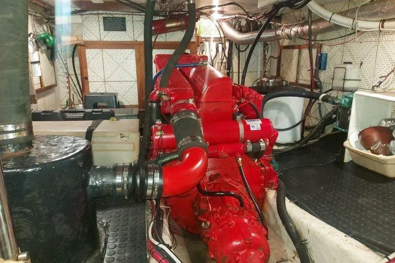 Kallisto Yacht Photos Pics Engine room of 1982 Kadey-Krogen Pilothouse with red machinery and piping.