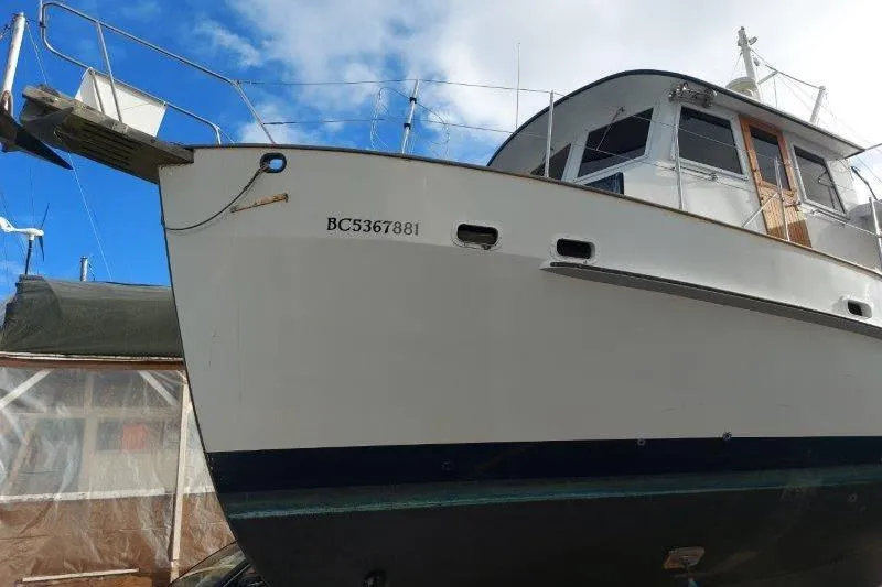 Kallisto Yacht Photos Pics 1982 Kadey-Krogen Pilothouse boat with registration BC5367881, docked under a blue sky.