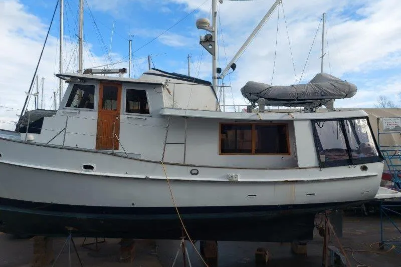 Kallisto Yacht Photos Pics 1982 Kadey-Krogen Pilothouse boat on dry dock, showcasing classic design and structure.